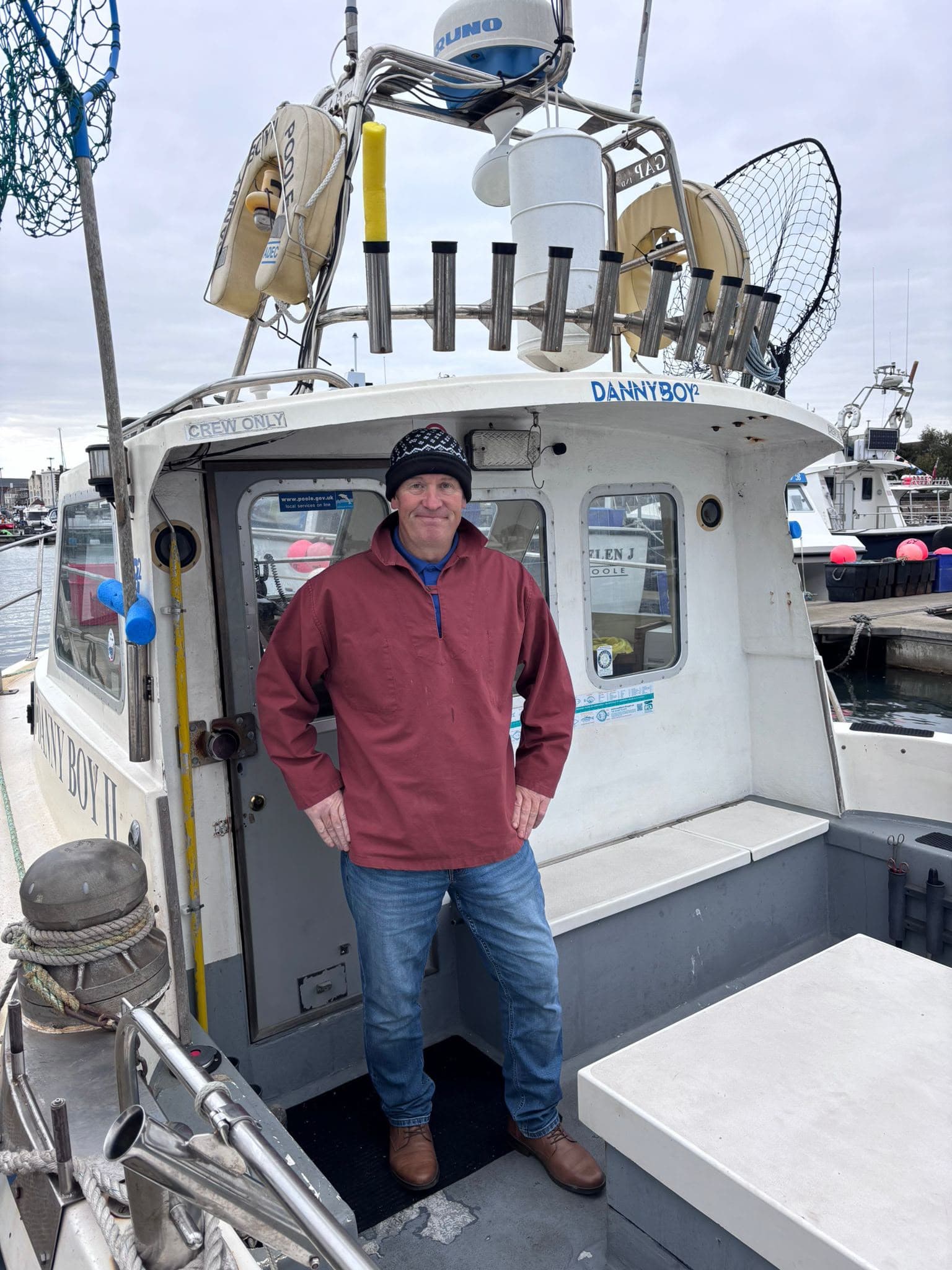 Angler on the deck of Danny Boy 2 fishing boat at the marina